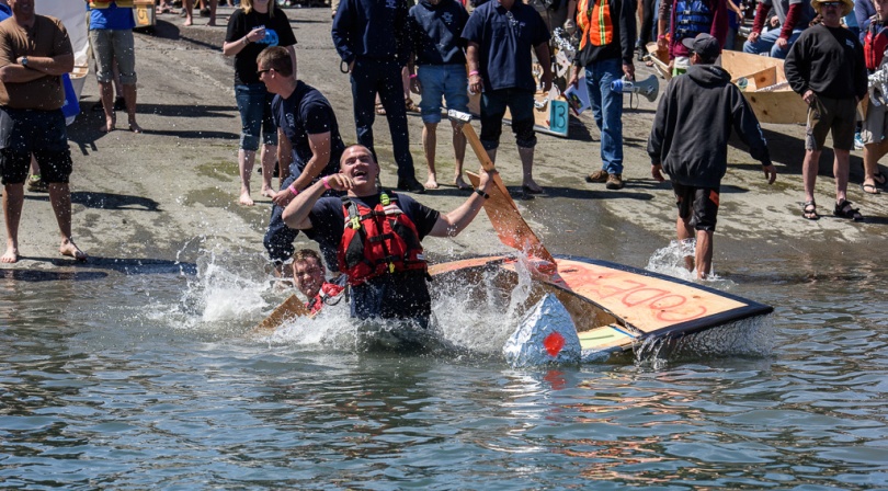 People falling out of a boat